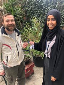 Iulian receiving the keys to his new home from hub worker, Zainab