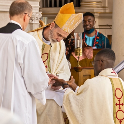 Bishop anoints hands with Oil of Chrism