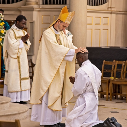 Bishop lays hands on Paschal's head