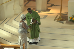 Paschal presents cloth to mother
