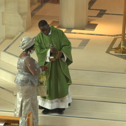 Paschal presents cloth to mother