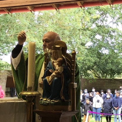 Mgr John Armitage lights candle for last time at Walshingham