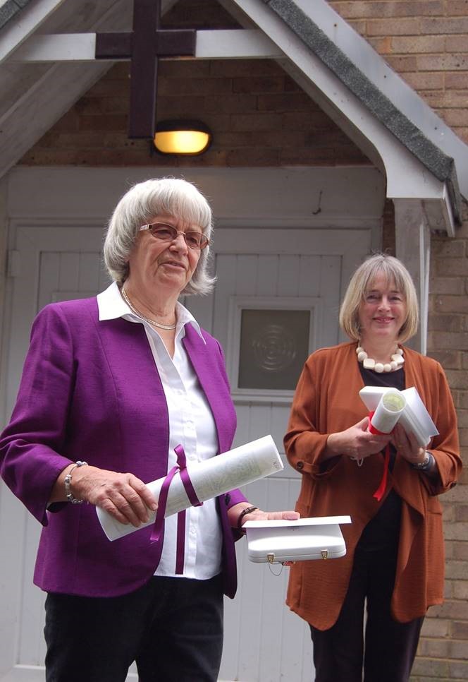 Margaret and Claire holding scrolls