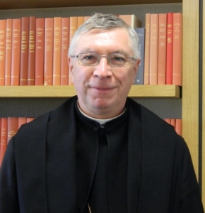 Abbot with books behind