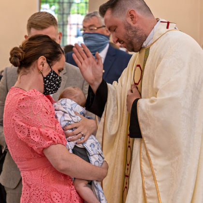 Priest blessing child