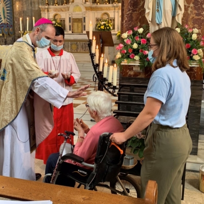 Bishop reaches out to pilgrim in wheelchair