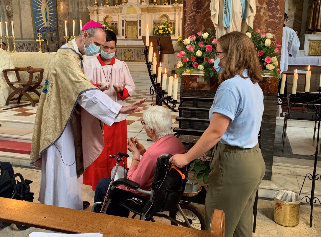 Bishop reaches out to pilgrim in wheelchair
