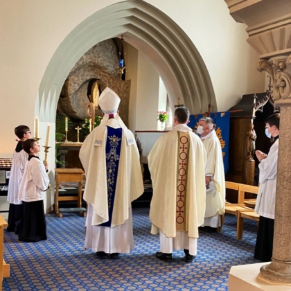 Backs of Bishop and priest in vestments