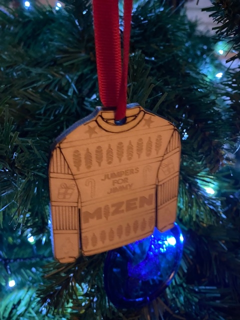 Wooden jumper shaped decoration hanging from tree