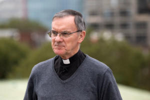 Man in clerical collar looking serious
