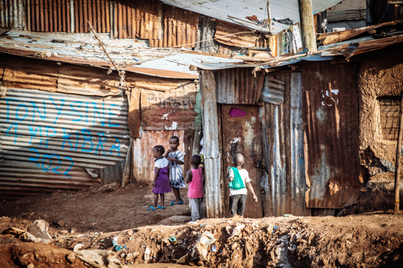 Children in front of corrugated iron slum