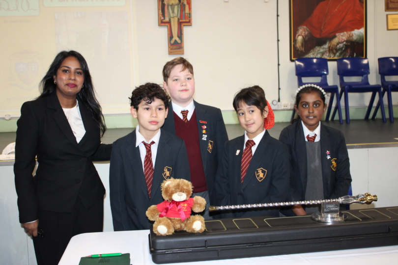 Uma Kumaran MP with children and mace