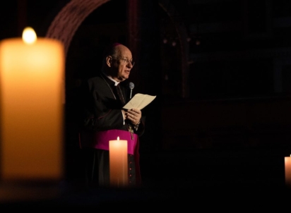 Archbishop flanked by candles